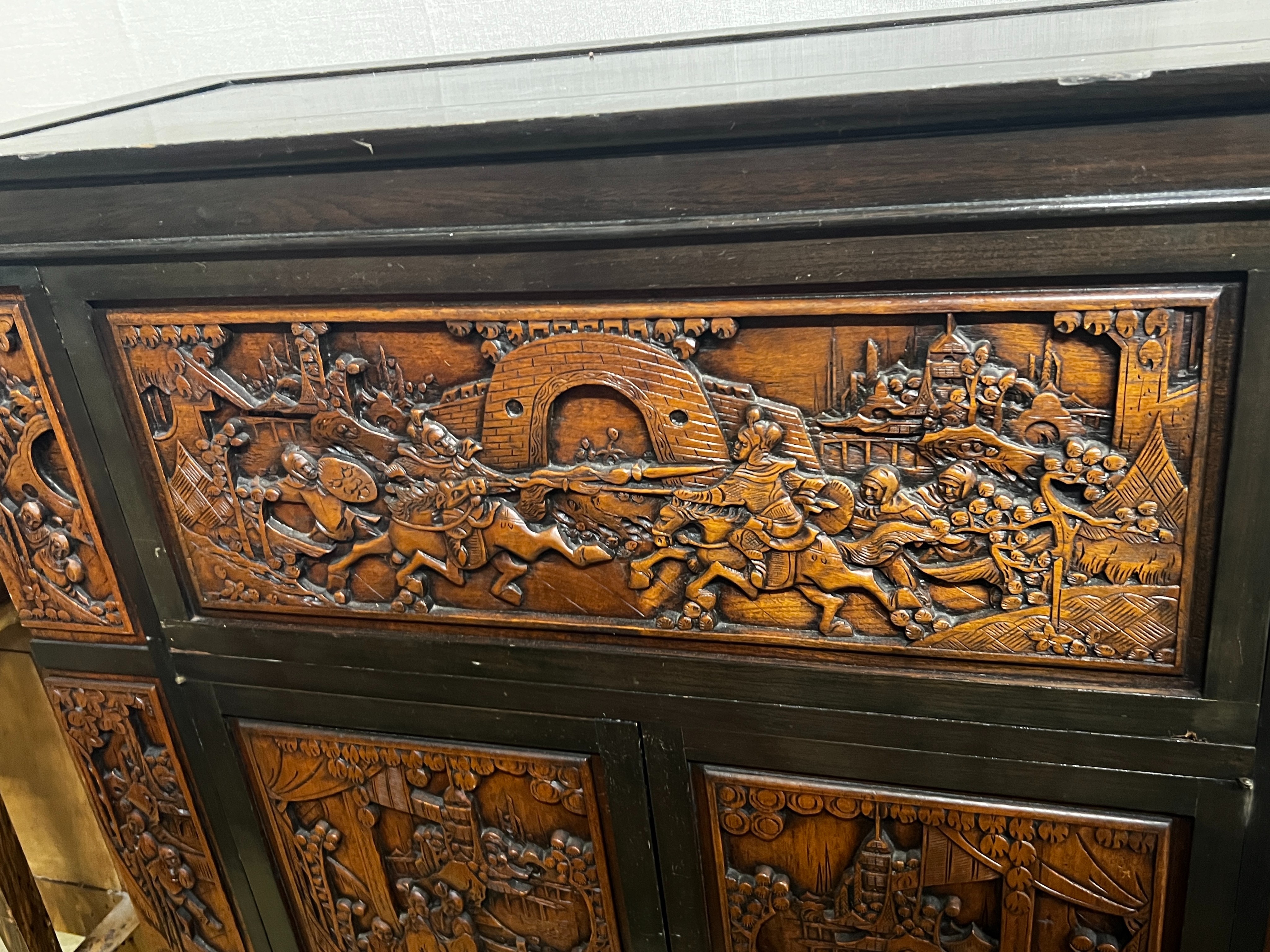 A Chinese carved hinged top cocktail cabinet with mirrored interior, width 111cm, depth 46cm, height 107cm